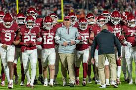 The Oklahoma Sooners football team walking the line before the game.